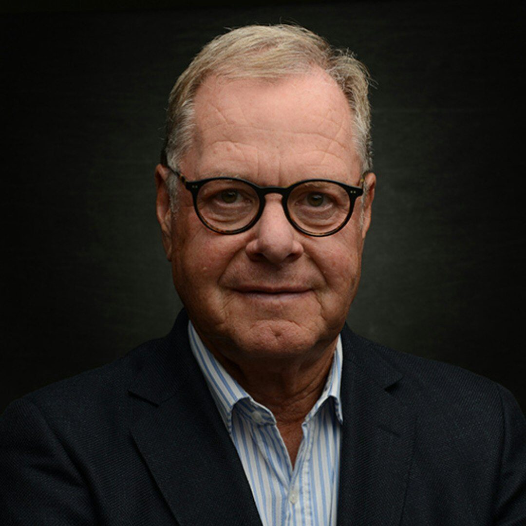 Studio portrait of a man journalist in a shirt and blazer