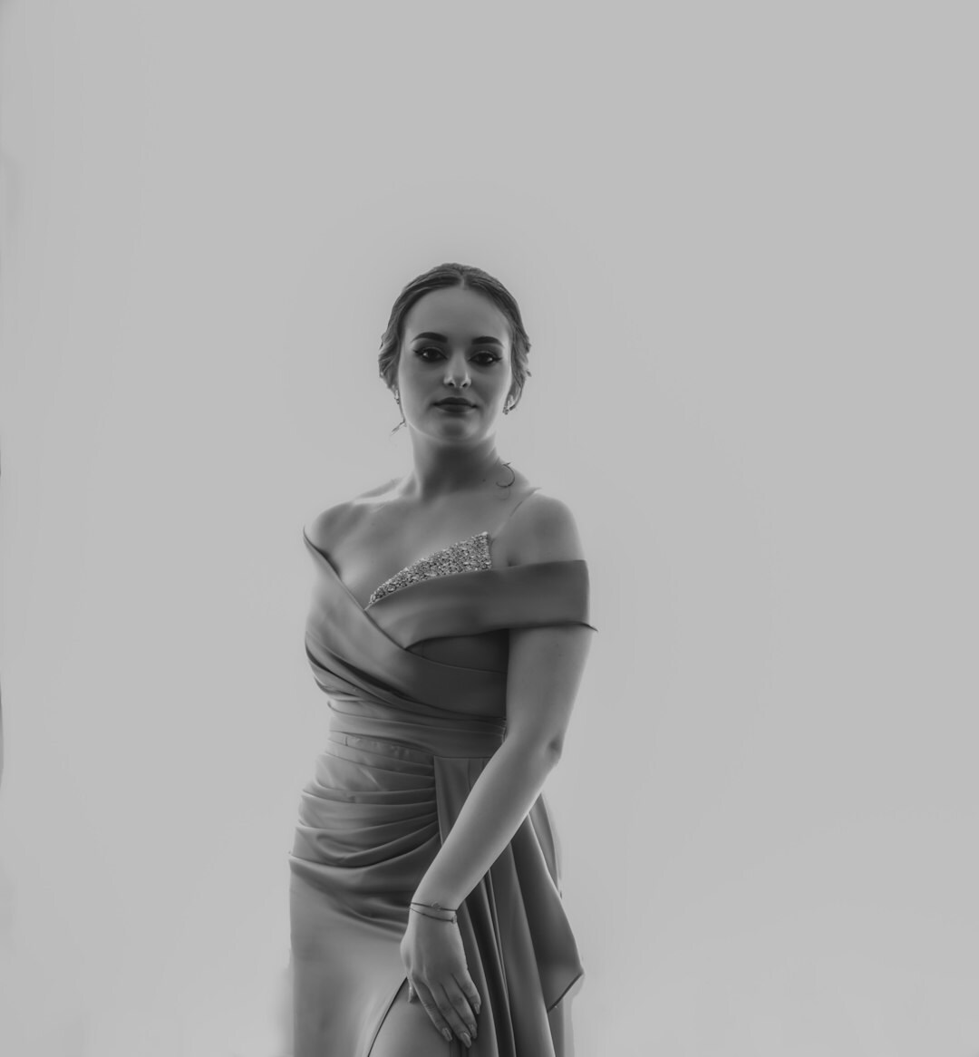 Actress posing on a red carpet in a designer gown