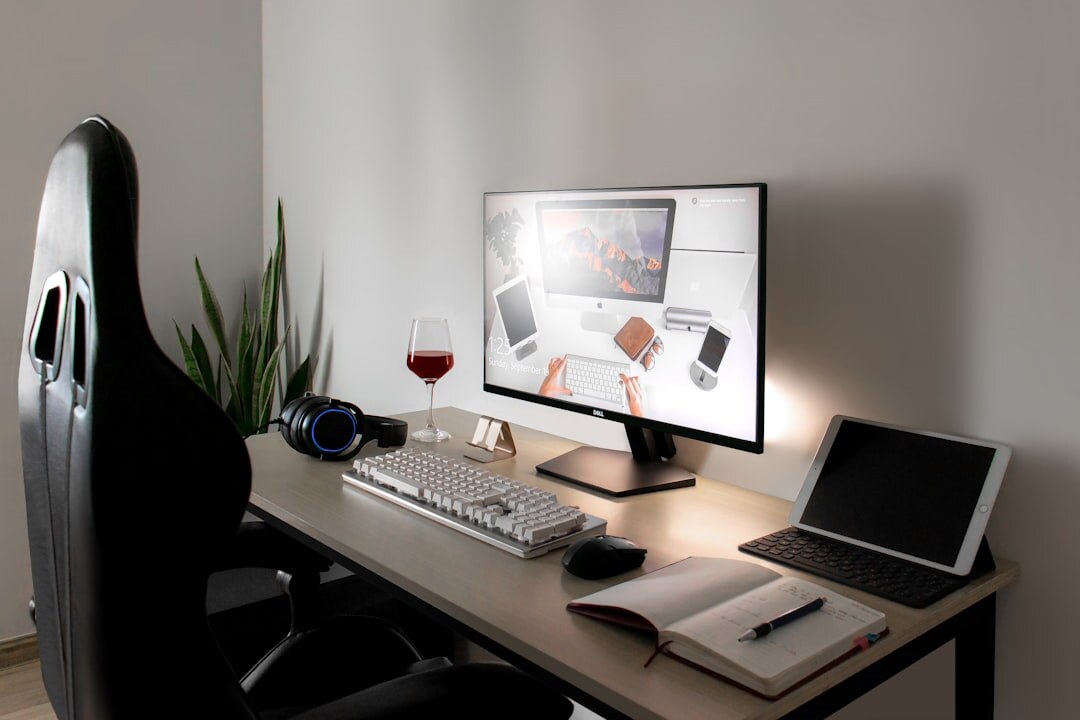 Bright editorial office desk with laptop and notebooks