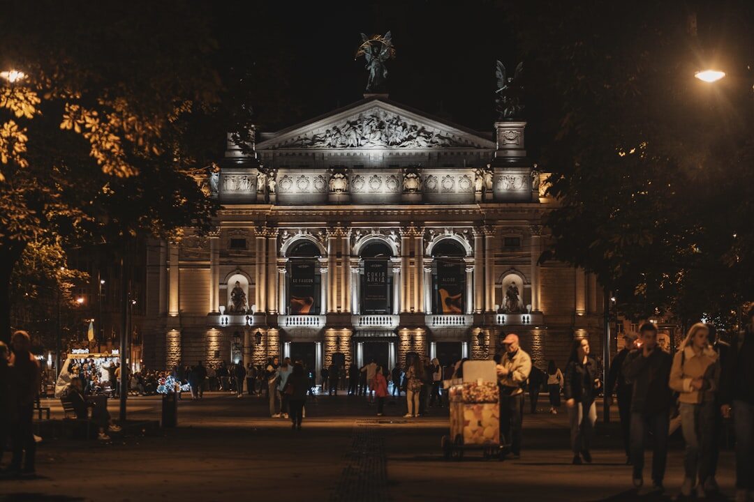 Grand illuminated opera house facade at night