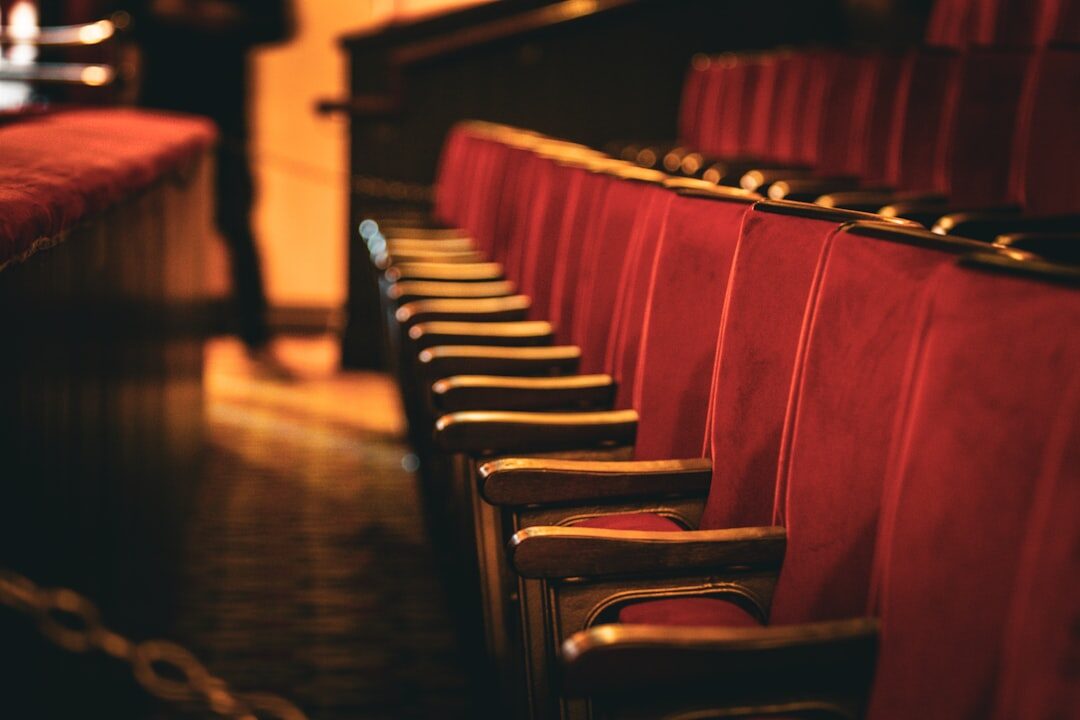 Ornate theater interior with red velvet seats and gilded balconies